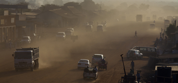 JUBA, SOUTH SUDAN - JULY 19: Dust is seen in the air as traffic moves along a major road under construction as the government continues to make improvements on the city's streets July 19, 2012 in Juba, South Sudan. South Sudan recently celebrated it's first anniversary of independence from Sudan. Repeated conflict with North Sudan, corruption scandals and economic difficulties have plagued the new country over the past year. Further problems caused by the shutdown of its oil production have led to a sharp decline in its currency and a rise in the price of food and fuel. (Photo by Paula Bronstein/Getty Images)