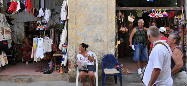 Vendors remain near their products in Havana on September 24, 2010. Cuba is to allow some houses to be rented in US dollars for the first time in 50 years as well as the opening up of small businesses as it seeks to shed 500,000 public jobs, state media said Friday. AFP PHOTO/STR (Photo credit should read STR/AFP/Getty Images)