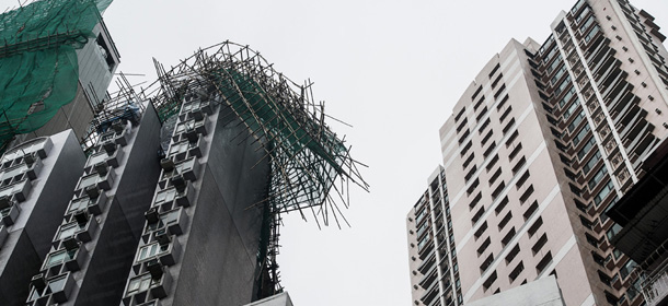 A scaffolding is seen collapsed atop a residential building in the aftermath of Typhoon Vincente in Hong Kong on July 24, 2012. More than 100 people were injured and trees were ripped from the ground as a typhoon lashed Hong Kong packing winds in excess of 140 kilometres (87 miles) an hour, officials said as authorities raised the typhoon warning to the most severe level of 10 for the first time since 1999. PHOTO / Philippe Lopez (Photo credit should read PHILIPPE LOPEZ/AFP/GettyImages)