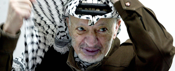RAMALLAH, -: (FILES) This file photo dated 12 April 2003 shows Palestinian leader Yasser Arafat adjusting his head-dress, keffiyeh, during a meeting in his Ramallah office. It was announced 11 November 2004 that Palestinian leader Yasser Arafat has died at a Paris hospital at the age of 75 after a prolonged illness. AFP PHOTO/JAMAL ARURI/FILES (Photo credit should read JAMAL ARURI/AFP/Getty Images)