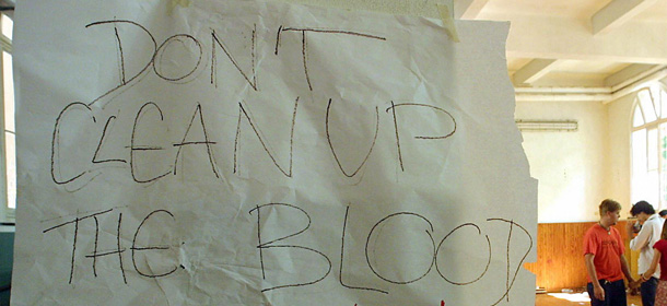 (FILES) This file picture taken on July 22, 2001 at a school in Genoa during a Group of Eight summit shows a note reading "Don't Clean Up The Blood" hanging in the headquarters of the umbrella anti-globalisation protest movement, the Genoa Social Forum (GSF) after an overnight police raid in Genoa. Genoa's tribunal condemned on November 13, 2008 13 Italian policemen for a total of 35 years and seven months of jail for the violence which took place at the Diaz school which was used as a dormitory by anti-globalists activists during the summit. 16 other policemen, including the three in charge of the security of the summit were acquitted. AFP PHOTO/FILES/GERARD JULIEN (Photo credit should read GERARD JULIEN/AFP/Getty Images)