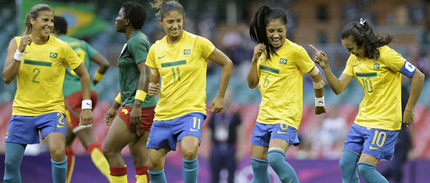 Brazil's Marta, right, celebrates after scoring with teammates Maurine, right, Cristiane and Fabiana, during the women's group E soccer match between Brazil and Cameroon, at the Millennium stadium in Cardiff, Wales, at the 2012 London Summer Olympics, Wednesday, July 25, 2012, in Cardiff. Brazil won 5-0. (AP Photo/Luca Bruno)