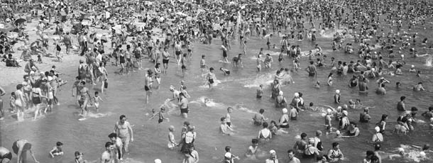 This general view from the Steeplechase Pier shows part of the crowded beach at Coney Island in Brooklyn, N.Y., Aug. 28, 1948. In the background beyond the boardwalk is the ferris wheel, center, and the Cyclone roller coaster at right. (AP Photo)