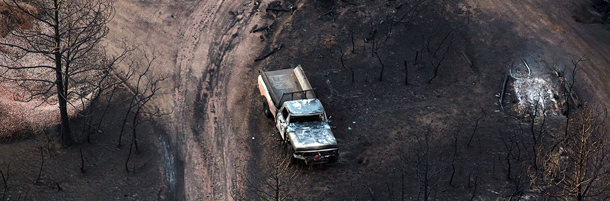 COLORADO SPRINGS, CO - JUNE 30: A burned truck is viewed in a neighborhood affected by the Waldo Canyon fire on June 30, 2012 in Colorado Springs, Colorado. The massive fire, which has eased with the help of cooler temperatures and lighter winds, has destroyed hundreds of homes and forced more than 35,000 people to flee. The fire was estimated at 17,073 acres and was 25 precent contained with some evacuees being let back into their neighborhoods. A second body has been located in a burned home while others are still reported missing. (Photo by Spencer Platt/Getty Images)