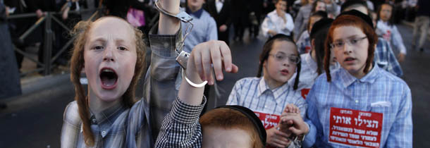 JERUSALEM, ISRAEL -JULY 16: (ISRAEL OUT) Ultra-Orthodox Jewish children wear handcuffs as they protest against a uniform draft law to replace the Tal Law on July 16, 2012, in Jerusalem, Israel. The Tal Law, which exempts ultra-Orthodox yeshiva students from mandatory military service, was declared unconstitutional by the High Court in February, and is due to expire in August. (Photo by Lior Mizrahi/Getty Images)