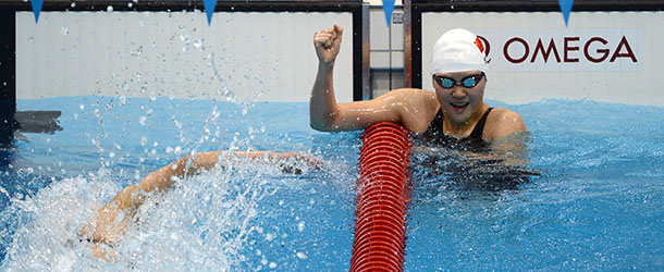 China's Ye Shiwen (R) celebrates after winning the women's 400m individual medley final swimming event at the London 2012 Olympic Games on July 28, 2012 in London. AFP PHOTO / CHRISTOPHE SIMON (Photo credit should read CHRISTOPHE SIMON/AFP/GettyImages)