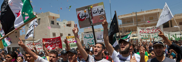 Syrians shout slogans during an anti-government demonstration after friday prayers in the city of Binnish in Idlib province on June 29, 2012. Demonstrations calling for the ouster of President Bashar al-Assad took place in Aleppo, Daraa, Deir Ezzor, Idlib, Homs and Latakia provinces as the Syrian Observatory for Human Rights said that at least 25 people were killed across Syria on June 29. AFP PHOTO/STR (Photo credit should read -/AFP/GettyImages)