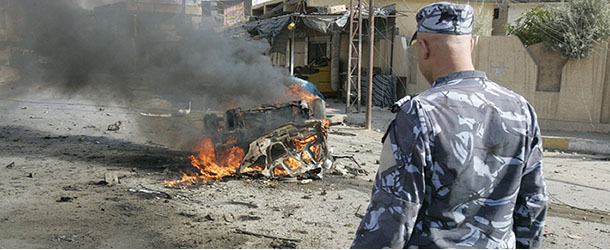 An Iraqi soldier looks at the burning shell of a car, one of a series of car bombs targeting army and police patrols in Kirkuk and the eponymous province's towns of Tuz Khurmatu and Dibis which killed at least five people and wounded 20 others on July 23, 2012. A spate of attacks in Baghdad and north of the capital killed at least 45 people, security and medical officials said, in an updated toll of earlier attacks. AFP PHOTO/MARWAN IBRAHIM (Photo credit should read MARWAN IBRAHIM/AFP/GettyImages)