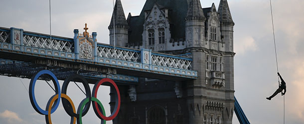 British Royal Marine Martyn Williams, right, rappels down from a Royal Navy Sea King helicopter into the Tower of London with the Olympic torch, Friday, July 20, 2012, in London. The Olympic Torch arrived in London after it was carried around England in a relay of torchbearers to make its way to the London 2012 Olympic Games opening ceremony on July 27, 2012. (AP Photo/Jae C. Hong)