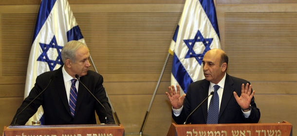 Israel's Prime Minister Benjamin Netanyahu, left, and Kadima party leader Shaul Mofaz hold a joint press conference announcing the new coalition government, in Jerusalem, Tuesday, May 8, 2012. Netanyahu said Tuesday his new coalition government will promote a "responsible" peace process with the Palestinians. (AP Photo/Sebastian Scheiner)