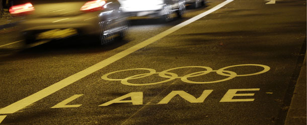 Vehicles drive next to a newly marked out Olympic Lane on the Embankment in London in preparation for the London 2012 Olympic Games, Sunday, July 1, 2012. (AP Photo/Sang Tan)