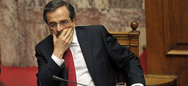 Greek Prime Minister Antonis Samaras sits at the Greek parliament in Athens on late July 8, 2012 prior to the confidence vote to the government. The coalition government of Antonis Samaras won the largely symbolic confidence vote, winning a comfortable mandate to tackle the country's two-year-old crisis. On July 9, at 0035 local time (July 8, 2135 GMT), more than half of Greek parliament's 300 lawmakers had voted in favour of conservative Samaras's centrist coalition that has promised voters a break from austerity while still meeting commitments made to EU-IMF creditors. AFP PHOTO / LOUISA GOULIAMAKI (Photo credit should read LOUISA GOULIAMAKI/AFP/GettyImages)