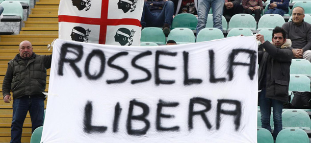 Cagliari supporters hold a banner for Rossella Urru, the Italian aid worker kidnapped in Algeria, prior to the Serie A soccer match between Cagliari and Siena, in Siena, Italy, March 4, 2012. (AP Photo/Paolo Lazzeroni)