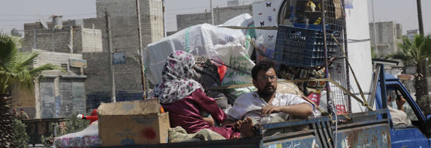 In this photograph made on Friday, July 27, 2012, Syrian civilians flee Aleppo, Syria. (AP Photo/Alberto Prieto)