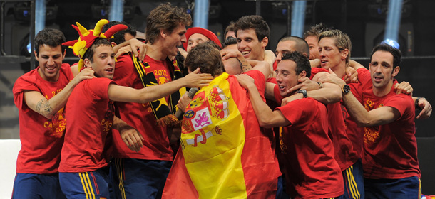 Spanish national football team players celebrate on July 2, 2012 on Cibeles Square in Madrid, a day after it won the final match of the Euro 2012 championships 4-0 against Italy in Kiev.
 AFP PHOTO / LLUIS GENE (Photo credit should read LLUIS GENE/AFP/GettyImages)