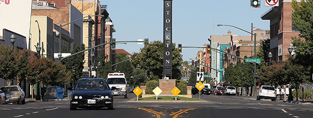 STOCKTON, CA - JUNE 27: Cars drive by a sign on June 27, 2012 in Stockton, California. Members of the Stockton city council voted 6-1 on Tuesday to adopt a spending plan for operating under Chapter 9 bankruptcy protection following failed talks with bondholders and labor unions failed. The move will make Stockton the biggest U.S. city to file for bankruptcy protection from creditors. (Photo by Justin Sullivan/Getty Images)