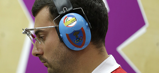 Italy's Luca Tesconi pauses before shooting in the men's 10-meter air pistol at the 2012 Summer Olympics, Friday, July 27, 2012, in London. (AP Photo/Darron Cummings)