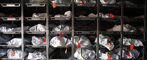 ** ADVANCE FOR USE WEDNESDAY, SEPT. 1, 2010 AND THEREAFTER ** FILE - This Thursday, July 29, 2010 file photo shows bags containing bodies at the Pima County morgue in Tucson, Ariz. At 59 deaths, July 2010 was the second-deadliest month for border-crossers in Arizona - second only to July 2005, when 68 bodies were found. (AP Photo/Jae C. Hong,File)