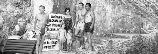 Mrs. Jacqueline Kennedy, her four-year-old daughter Caroline, left, and two-year-old newphew Anthony Radziwill, shown next to a Ã¬Welcome JacquelineÃ® poster at the first beach outing of their Italian vacation at Ravello, Italy on August 9, 1962. Mrs. Kennedy wears a pea-green, one-piece bathing suit. (AP Photo/Girolamo Di Majo)