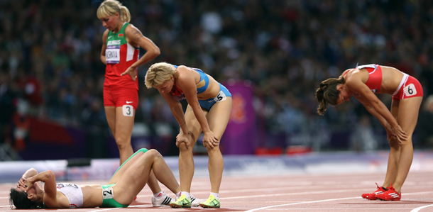 LONDON, ENGLAND - AUGUST 04: Exhausted heptathletes look on after the Women's heptathlon 800m on Day 8 of the London 2012 Olympic Games at Olympic Stadium on August 4, 2012 in London, England. (Photo by Streeter Lecka/Getty Images)