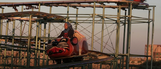 Palestinian families enjoy a ride in an amusement park on the third day of Eid al-Fitr, marking the end of Islam's fasting holy month of Ramadan, in Gaza City on August 21, 2012. AFP PHOTO/MAHMUD HAMS (Photo credit should read MAHMUD HAMS/AFP/GettyImages)