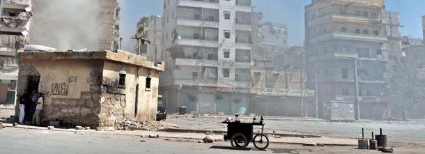 Civilians take cover as Syrian government shell the northern Syrian city of Aleppo on August 25, 2012. Syrian rebels say they are digging in for a war of attrition in Aleppo, where what was being billed as the "mother of all battles" is now dragging on into a second month of bloody stalemate. AFP PHOTO / ARIS MESSINIS (Photo credit should read ARIS MESSINIS/AFP/GettyImages)