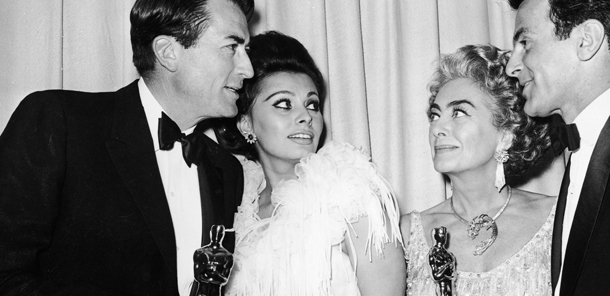 L-R: Actors Gregory Peck (1916 - 2003), Sophia Loren, Joan Crawford (1904 - 1977) and Fernando Lamas (1915 - 1982) stand backstage at the Academy Awards, Santa Monica Civic Auditorium, Los Angeles, California, April 8, 1963. Both Peck and Crawford hold Oscar statuettes. Peck won Best Actor for director Robert Mulligan's film "To Kill a Mockingbird." Crawford accepted the Best Actress award for Anne Bancroft for director Arthur Penn's film "The Miracle Worker." (Photo by Hulton Archive/Getty Images)