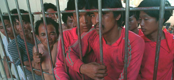 PUERTO PRINCESA, PHILIPPINES: Some of 62 Chinese fishermen charged with illegal fishing stand locked up inside a provincial jail on the Western Philippine island of Palawan 31 March 1995. The fishermen were aboard four Chinese fishing boats that the Philippine Navy seized in the disputed Spratly Islands group in the South China Sea 25 March. The Philippines has turned down calls from China for the fishermen's release.AFP PHOTO (Photo credit should read ROMEO GACAD/AFP/Getty Images)