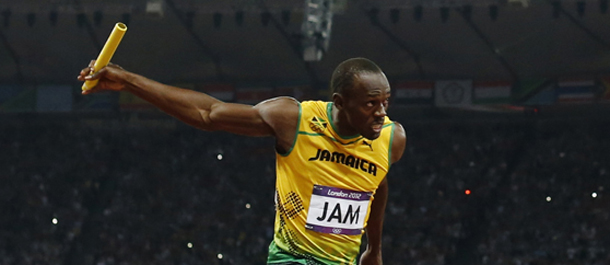 Jamaica's Usain Bolt, right, crosses the finish line ahead of Ryan Bailey of the United States in the men's 4x100-meter relay final during the athletics in the Olympic Stadium at the 2012 Summer Olympics, London, Saturday, Aug. 11, 2012. Jamaica set a new world record with a time of 36.84 seconds. (AP Photo/Matt Dunham)