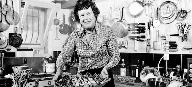 FILE-This Aug. 21, 1978 file photo shows chef Julia Child showing a salade nicoise she prepared in the kitchen of her vacation home in Grasse, southern France. Julia Child, who brought the intricacies of French cuisine to Americans through her television series and books, died on Aug. 13, 2004. She was 91. (AP Photo/File)