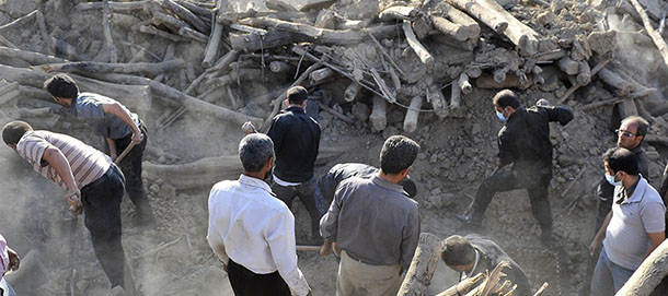 Iranians search the ruins of buildings at the village of Bajebaj near the city of Varzaqan in northwestern Iran, on Sunday, Aug. 12, 2012, after Saturday's earthquake. Twin earthquakes in Iran have killed at least 250 people and injured over 2,000, Iranian state television said on Sunday, after thousands spent the night outdoors after their villages were leveled and homes damaged in the country's northwest. Iran is located on seismic fault lines and is prone to earthquakes. It experiences at least one earthquake every day on average, although the vast majority are so small they go unnoticed. (AP Photo/ISNA, Arash Khamoushi)