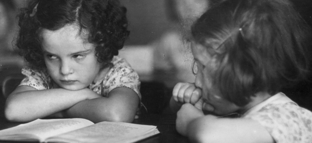 circa 1950: Two little girls enduring a dull lesson at primary school. (Photo by Erich Auerbach/Getty Images)