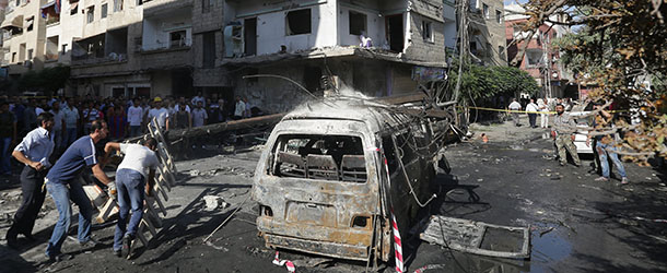 Syrians inspect damage at the site of a car bomb in the mainly Druze and Christian suburb of Jaramana on the southeastern outskirts of the Syrian capital on August 28, 2012. AFP PHOTO/JOSEPH EID (Photo credit should read JOSEPH EID/AFP/GettyImages)