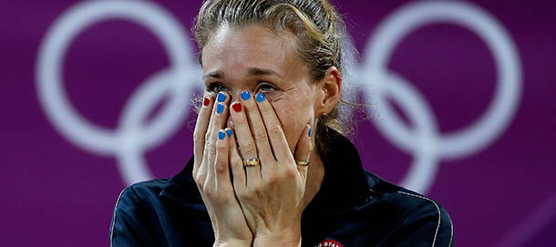 LONDON, ENGLAND - AUGUST 08: Kerri Walsh Jennings celebrates on the podium during the medal ceremony for the Women's Beach Volleyball on Day 12 of the London 2012 Olympic Games at the Horse Guard's Parade on August 8, 2012 in London, England. (Photo by Jamie Squire/Getty Images)