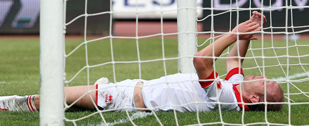 In this picture made available on Monday, April 2, 2012, Bari's defender Andrea Masiello reacts after scoring an own goal during the Serie A Bari vs Lecce soccer match in Bari, Italy on May 15, 2011. Andrea Masiello has been arrested by the Carabinieri national police in his home in Bergamo in the early hours of Monday morning, April 2, 2012, in the ongoing Italian probe into match-fixing. According to Italian Football Federation, also eight of his former Bari teammates are under investigation. The federation called the arrests "sensational developments" and promised to take "swift action" against the players if they are found guilty. Bari's last nine matches in Serie A last season are being looked into, including the derby in which Masiello's own goal helped Lecce win 2-0 to avoid relegation after Bari had already been relegated. (AP Photo/Donato Fasano)