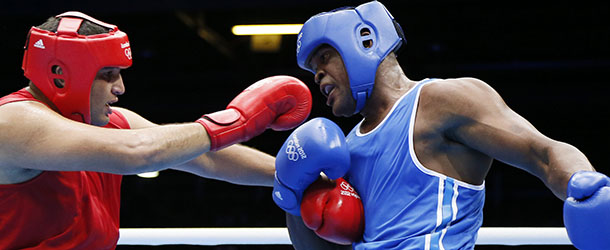Mohammed Arjaoui (L) of Morocco trades punches with Blaise Yepmou Mendouo (R) of Cameroon during their round of 16 Super-heavyweight (+91kg) boxing match of the London 2012 Olympics at the ExCel Arena August 1, 2012 in London. Arjaoui was awarded a 15-6 points decision. AFP PHOTO / Jack GUEZ (Photo credit should read JACK GUEZ/AFP/GettyImages)