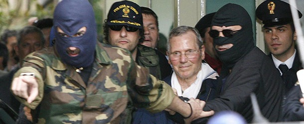 FILE - In this Tuesday, April 11, 2006 file photo, Mafia boss Bernardo Provenzano is escorted by hooded police officers as he enters a Police building in downtown Palermo, Italy. (AP Photo/Luca Bruno, File)