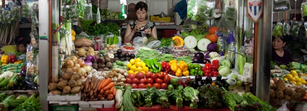 A vendor stands behind a vegetable stall in Beijing on August 9, 2012. Chinese inflation hit a two-and-a-half-year low in July, official data showed, giving the government further policy leeway to boost weakening growth. AFP PHOTO / Ed Jones (Photo credit should read Ed Jones/AFP/GettyImages)