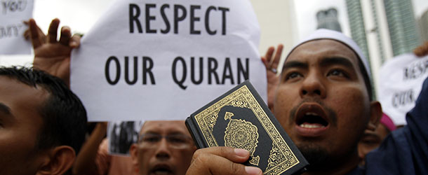 A Muslim protester holds a copy of Quran as he shouts slogans during a protest against the burning of Qurans in Afghanistan by U.S. troops, outside the U.S. Embassy in Kuala Lumpur, Malaysia, Friday, Feb. 24, 2012. U.S. President Barack Obama apologized to Afghans for the burning of Qurans at a U.S. military base in Afghanistan, trying to assuage rising anti-American sentiment as an Afghan soldier gunned down two American troops during another day of angry protests. (AP Photo/Lai Seng Sin)