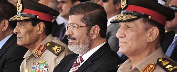 FILE - In this Thursday, July 5, 2012 file image released by the Egyptian President, Egyptian Field Marshal Gen. Hussein Tantawi, left, new President Mohammed Morsi, center, and Armed Forces Chief of Staff Sami Anan, right, attend a medal ceremony, at a military base east of Cairo, Egypt. The spokesman for Egyptâs president says Mohammed Morsi, the countryâs Islamist leader, has decided to retire the head of the Armed Forces and minister of Defense and chief of staff. (AP Photo/Sherif Abd El Minoem, Egyptian Presidency, File)