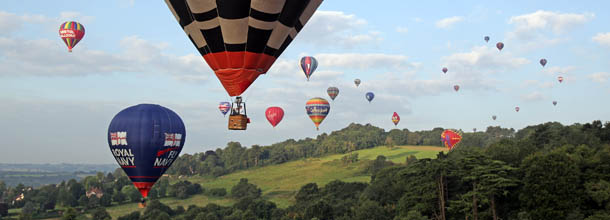 BRISTOL, ENGLAND - AUGUST 10: Hot air balloons take to the skies from Ashton Court at the Bristol International Balloon Fiesta on August 10, 2012 in Bristol, England. The early morning flight of nearly 100 balloons over the city was the first mass ascent of the four-day Bristol International Balloon Fiesta which started on Thursday. Now in its 34th year, the Bristol International Balloon Fiesta is Europe's largest annual hot air balloon event in the city that is seen by many balloonists as the home of modern ballooning. (Photo by Matt Cardy/Getty Images)