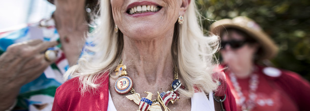 MANASSAS, VA - AUGUST 11: Alice Butler-Short, of Norton, Virginia, center, wears a homemade necklace while waiting in line to enter the Harris Pavilion to hear Republican presidential candidate, former Massachusetts Gov. Mitt Romney speak at a campaign rally with newly appointed vice presidential candidate, U.S. Rep. Paul Ryan (R-WI) on August 11, 2012 in Manassas, Virginia. "He couldn't have done better," Butler-Short said of Romney's pick of Ryan for a running mate, adding, "we're gonna rock and roll with R and R." Ryan, a seven term congressman, is Chairman of the House Budget Committee and provides a strong contrast to the Obama administration on fiscal policy. (Photo by T.J. Kirkpatrick/Getty Images)
