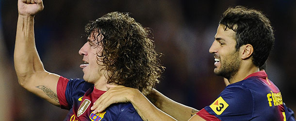 BARCELONA, SPAIN - AUGUST 19: Carles Puyol of FC Barcelona (L) celebrates with his teammates Cesc Fabregas of FC Barcelona after scoring the opening goal during the La Liga match between FC Barcelona and Real Sociedad de Futbol at Camp Nou on August 19, 2012 in Barcelona, Spain. (Photo by David Ramos/Getty Images)