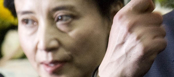 In this Jan. 17, 2007 photo, Bo Xilai, right, then China's Minister of Commerce, and his wife Gu Kailai, left, attend a memorial ceremony for Bo's father Bo Yibo, a late revolutionary leader considered one of communist China's founding fathers, at a military hospital in Beijing. Prosecutors charged the wife of ousted Chinese politician Bo and a family aide Zhang Xiaojun with the murder of a British businessman, the government said Thursday, July 26, 2012, pushing ahead a case at the center of a messy political scandal that unsettled China's leadership ahead of a delicate power transition. (AP Photo/Alexander F. Yuan)