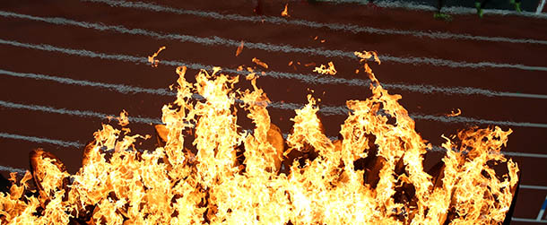 LONDON, ENGLAND - AUGUST 05: Competitors in the Men's 1500m Semifinal run past the Olympic torch on Day 9 of the London 2012 Olympic Games at the Olympic Stadium on August 5, 2012 in London, England. (Photo by Jeff J Mitchell/Getty Images)