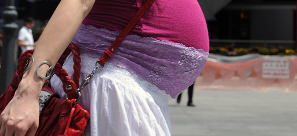 In this photo dated January 19, 2009 a pregnant woman walks down the street of the financial district in Singapore. A Singapore lawmaker has a simple explanation for the city-state's lack of babies: procreation, he says, is "not our forte." Loo Choon Yong also suggested that because more free time did not necessarily result in more babies, people should work on Saturdays, a report in The Straits Times said. "We should accept that as a people, our procreation talent is not our forte -- nothing to crow about," Loo told the legislature on February 4. AFP PHOTO/ROSLAN RAHMAN (Photo credit should read ROSLAN RAHMAN/AFP/Getty Images)