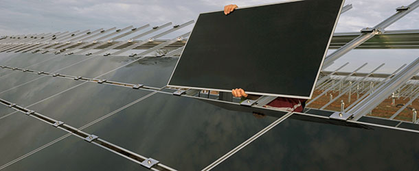 A worker puts on solar panels on November 10, 2011 shows in Crucey-Villages, central France, on the building site of a photovoltaic park built by French Energy Giant EDF on a former NATO military base. AFP PHOTO/ALAIN JOCARD (Photo credit should read ALAIN JOCARD/AFP/Getty Images)