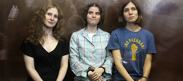 Members of the all-girl punk band "Pussy Riot" Nadezhda Tolokonnikova (R), Maria Alyokhina (L) and Yekaterina Samutsevich sit in a glass-walled cage after being sentenced in Moscow on Agust 17, 2012. A Moscow court today handed a two-year prison sentence to three feminist punk rockers who infuriated the Kremlin and captured world attention by ridiculing President Vladimir Putin in Russia's main church. Pussy Riot release rallies have stretched from Sydney to New York as a growing list of celebrities joined ex-Beatle Paul McCartney and pop icon Madonna in a campaign directed against Putin's crackdown on dissent. 
AFP PHOTO / STR (Photo credit should read -/AFP/GettyImages)