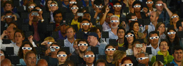 Spectators wear 3d glasses during the opening ceremony of the London 2012 Olympic Games on July 27, 2012 at the Olympic stadium in London. AFP PHOTO / LEON NEAL (Photo credit should read LEON NEAL/AFP/GettyImages)