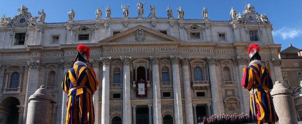 VATICAN CITY, VATICAN - DECEMBER 25: Two guards stand in front of St Peter's Basilica as Pope Benedict XVI delivers his Christmas Day message 'urbi et orbi' blessing (to the city and to the world) from the central balcony of St Peter's Basilica on December 25, 2011 in Vatican City, Vatican. (Photo by Franco Origlia/Getty Images)